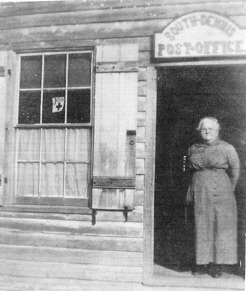 Older woman standing in doorway of South Dennis post office