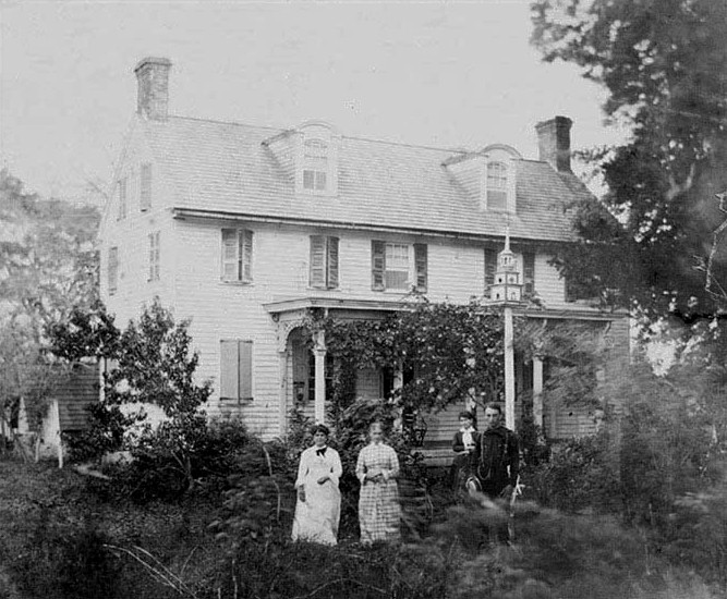 The Edward’s House with two women and two me standing in front